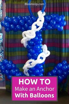 balloons are arranged in the shape of an anchor with white and blue links on it