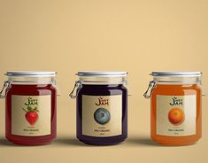 three jars of jam with labels on them, one containing blueberries and the other containing oranges