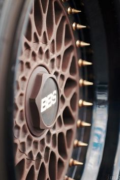 closeup of the spokes and hubs on a car's wheel rim