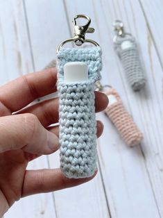 a crocheted keychain is being held by someone