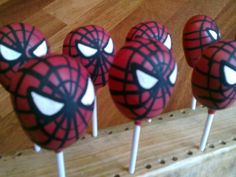 spiderman lollipops are lined up on sticks