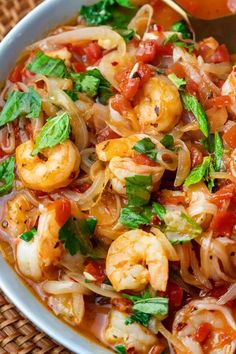 a white bowl filled with pasta and shrimp