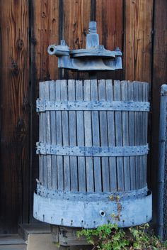 an old wooden barrel sitting in front of a fence