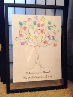 a family tree with handwritten names and hearts on it is displayed in a shadow box