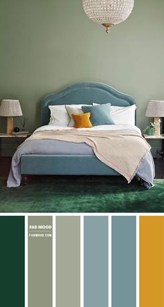 a bedroom with green walls and blue bed in the center, yellow pillows on the headboard