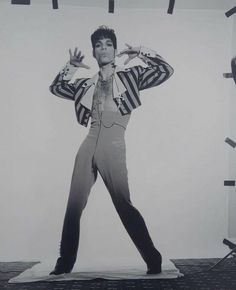 elvis presley standing in front of a white background