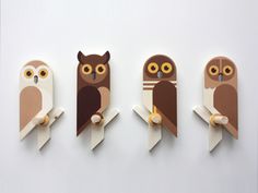 three owls sitting on top of each other in front of a white wall with four different shapes