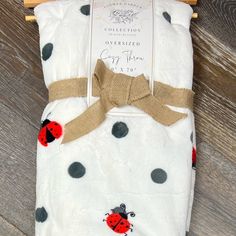 a ladybug blanket on a wooden hanger