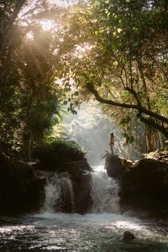 a person standing at the top of a waterfall