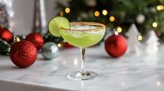 The Holly Jolly Margarita is a refreshing twist on the classic margarita, featuring the sweet, fruity flavor of Midori melon liqueur paired with the boldness of tequila and a tangy kick from lime juice. A Tajín-rimmed glass adds a touch of spice, making this drink as visually appealing as it is delicious. Holly Jolly Margarita Berry Cocktail, White Cranberry Juice, Paloma Cocktail, Cranberry Cocktail, Sugared Cranberries, Sweet Cocktails, Mint Sprig, Tequila Cocktails