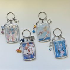 four different key chains with pictures on them