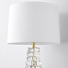 a table lamp with a white shade on it