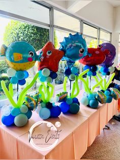 there are many balloons that look like fish on the table