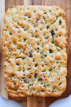 a loaf of bread sitting on top of a wooden cutting board