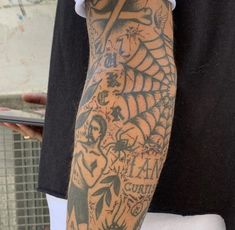 a man with a spider web tattoo on his arm