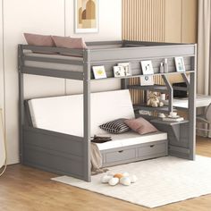 a bunk bed with a desk underneath it in a room that has hardwood floors and white walls