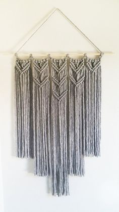 a wall hanging made out of yarn with fringes