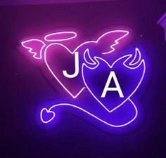 a neon sign that says j a with an angel heart and the letter a underneath it