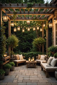 an outdoor seating area is lit up with lanterns