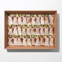 a box filled with lots of food on top of a white table next to a wall