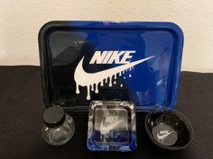 a blue nike lunch box with two containers and one container filled with water, salt and pepper shakers