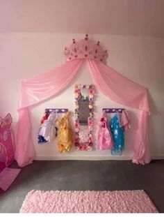 a princess bedroom with pink walls and curtains