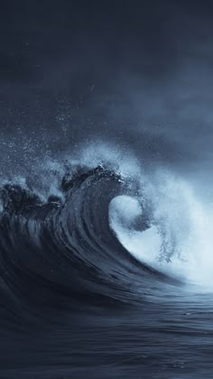 an ocean wave is breaking in the dark