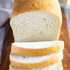 a loaf of bread sitting on top of a wooden cutting board