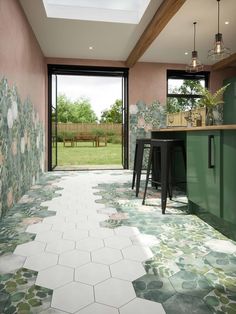 a kitchen with green and white tiles on the floor