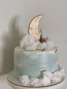 there is a cake with clouds and a moon on top