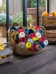 a basket filled with lots of different colored towels