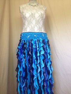 This one of a kind mermaid belt skirt is a unique wearable art piece that is made from reclaimed fabrics and comes with an adjustable pocket.  Wearing this garment will give you a nigh irresistible urge to spin around and shimmy and smile. The Fabulous Fishies belt is like wearing a school of fish adorning the top of the the belt and seaweed-y spirals that dance and flow at your slightest movement while not hampering your motion.  It is a two piece belt that is fastened on the body with lacings on both hips for maximum flexibility in sizing.  It is lined with cotton fabric for comfort. This belt measures about 38 inches in length and is approximately 5.5 inches wide.  I recommend a hip size range of 40 to 52 inches. The belt comes with two removable pockets that hook on to grommets in the Seaweed Clothes, Seaweed Inspired Fashion, Mermaid Belt, Sea Shell Belt, Fish Belt, Purple Mermaid Shell Top, Patchwork Denim Skirt, Mermaid Outfit, Blue Tweed