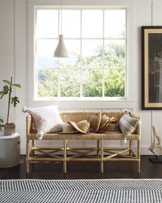 a living room filled with furniture next to a window and potted plant in the corner