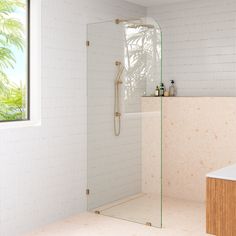 a bathroom with a walk in shower next to a bathtub and sink under a window