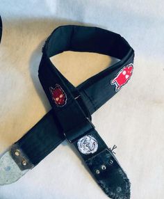 a black strap with red and white patches on it