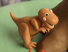 a close up of a toy dinosaur on a table