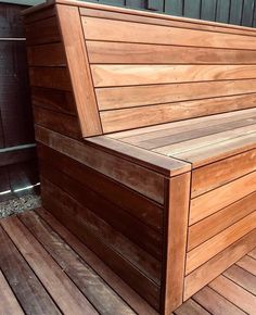 a wooden bench sitting on top of a wooden deck