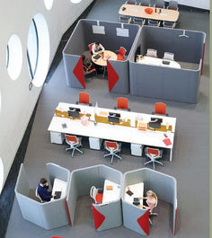 an office cubicle with people working at desks