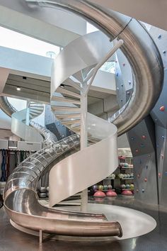 an indoor climbing wall with a spiral staircase