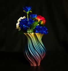 a vase filled with colorful flowers on top of a table