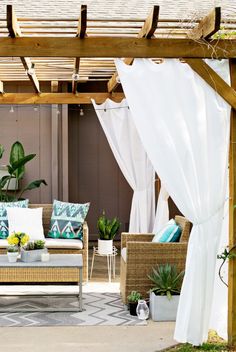 an outdoor living area with couches, tables and potted plants on the patio