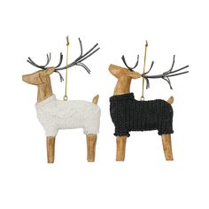 two wooden reindeer ornament with black and white sweaters hanging from their antlers