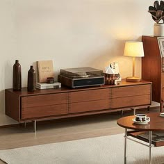 a living room filled with furniture next to a wall mounted clock and table top tv