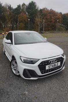 a white car parked in a parking lot