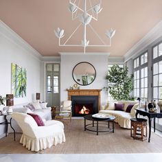 a living room filled with furniture and a fire place in the middle of a room