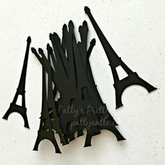 the eiffel tower is made out of black paper and cut into smaller shapes