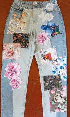 a pair of jeans with patches and flowers on them