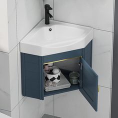 a bathroom sink sitting under a mirror next to a wall mounted faucet and towel dispenser