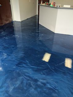 a room with blue floors and white walls