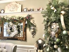 a decorated christmas tree in front of a mirror and fireplace mantel with ornaments on it